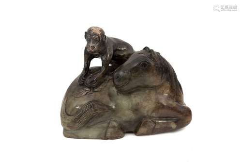 A carved jade sculpture, depicting a reclining horse with a ...