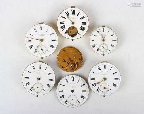 A collection of pocket watch movements and dials, including ...