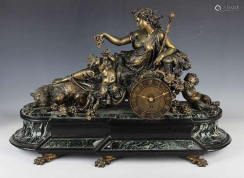 A late 19th century bronze, slate and marble mantel timepiec...