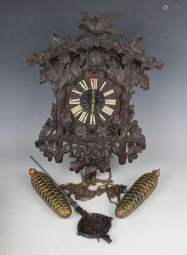 A late 19th century Black Forest carved oak cuckoo wall cloc...