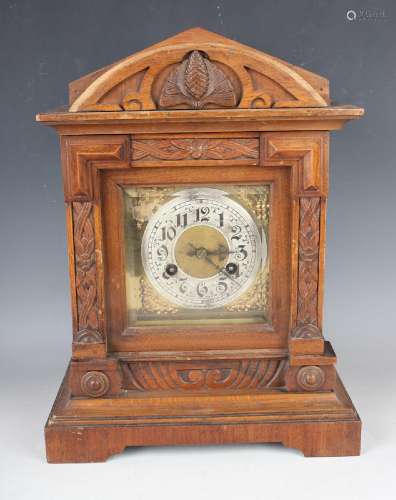 A late 19th century German walnut mantel clock with Junghans...