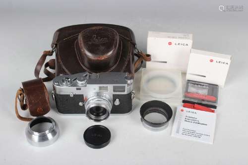 A Leica M2 camera, No. 989771, circa 1960, with Leitz Elmar ...