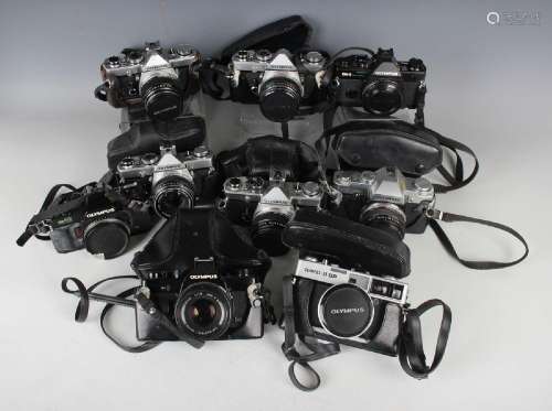 A collection of ten Olympus cameras, including M-1 with Zuik...