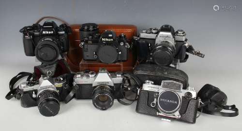 A collection of 35mm cameras, including Nikon F90X with Nikk...