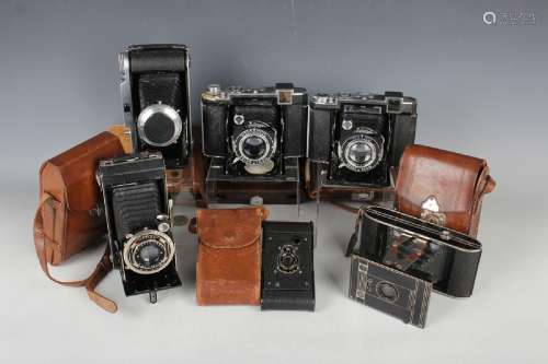 A collection of twenty-seven folding cameras, including two ...