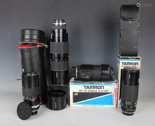 A collection of assorted camera lenses, including Tamron 1:4...