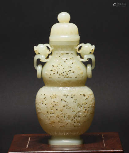 A hetian jade hollow 'floral' gourd-shaped vase with two ear...