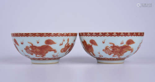 An allite red glazed 'lions sporting with an embroidered bal...