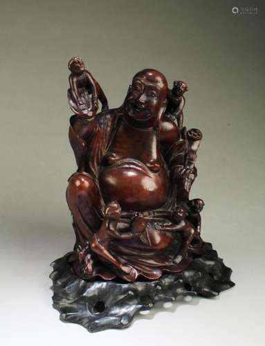 A CARVED WOODEN SMILING BUDDHA STATUE