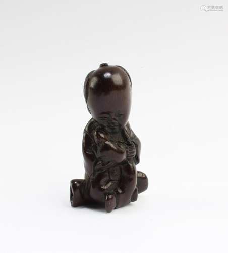 A CARVED WOODEN FIGURINE