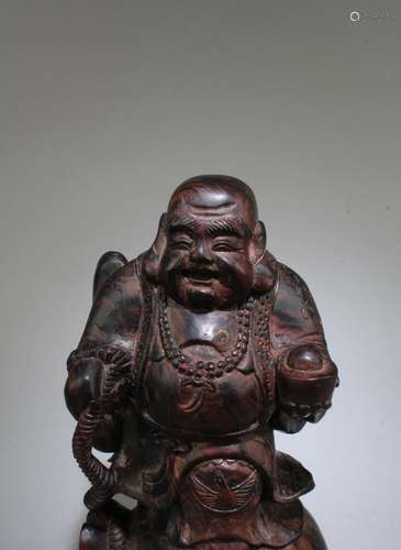 A Carved Wooden Smiling Buddha Statue