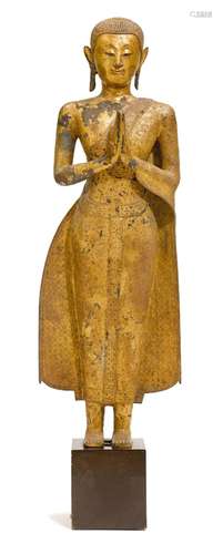 A LACQUER GILT BRONZE FIGURE OF A STANDING MONK.Thailand, 19...