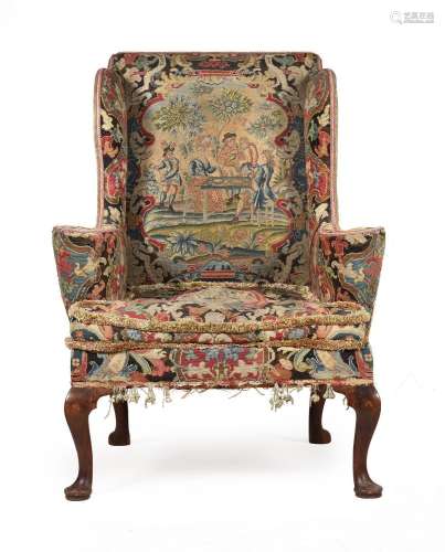 AN EARLY GEORGE II WALNUT AND NEEDLEWORK UPHOLSTERED WING AR...
