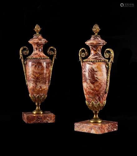 A PAIR OF FRENCH RED FLUORSPAR AND GILT BRASS MOUNTED URNS, ...