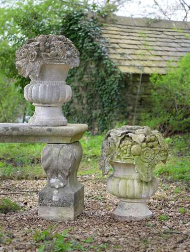 A PAIR OF CARVED LIMESTONE BASKETS OF FRUIT, EARLY 20TH CENT...