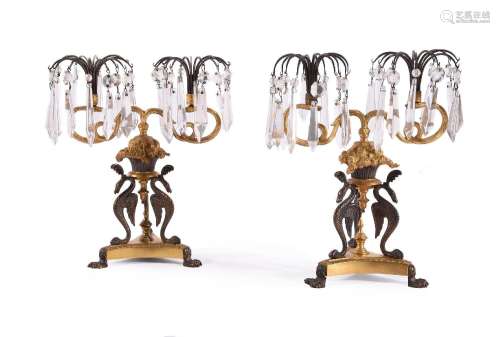 A PAIR OF REGENCY GILT AND PATINATED BRONZE TWIN-LIGHT TABLE...