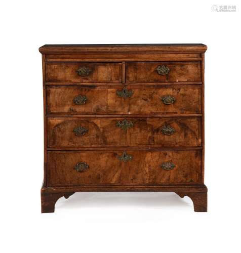 A GEORGE II WALNUT AND ELM CHEST OF DRAWERS, CIRCA 1735