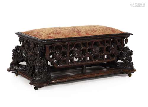 A CARVED OAK OTTOMAN STOOL, IN THE ANTIQUARIAN TASTE, 19TH C...