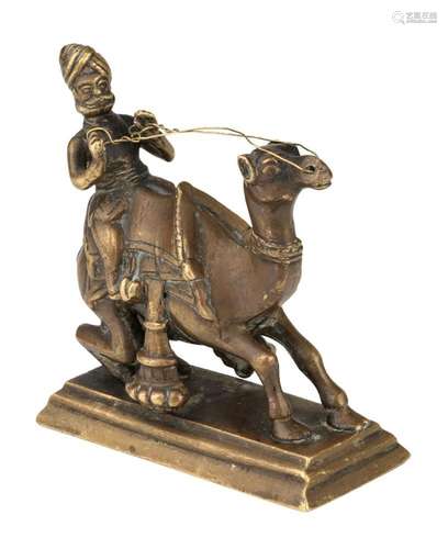 A brass model of a camel and rider