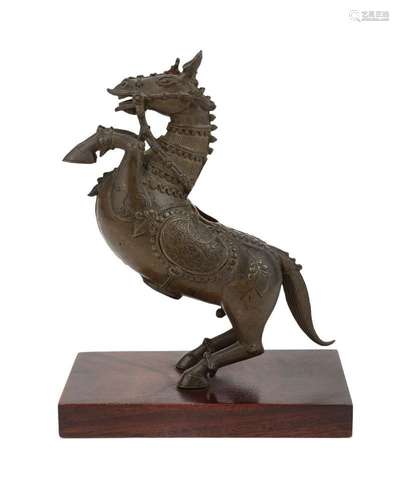 A bronze figure of a prancing horse