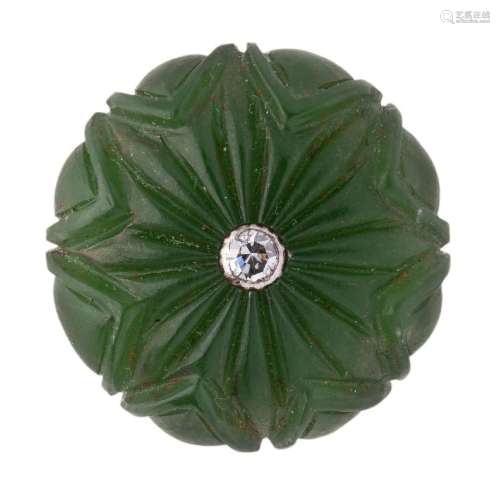 A carved jade button with central diamond
