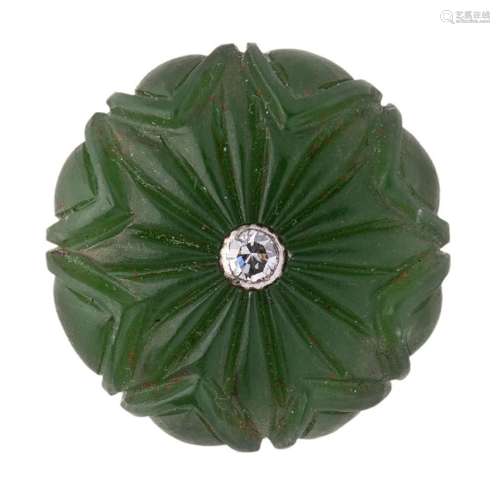 A carved jade button with central diamond