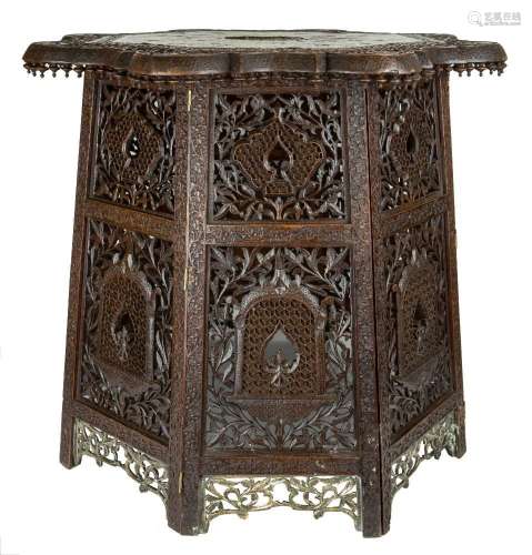 A brass and copper inlaid carved wood table top and stand
