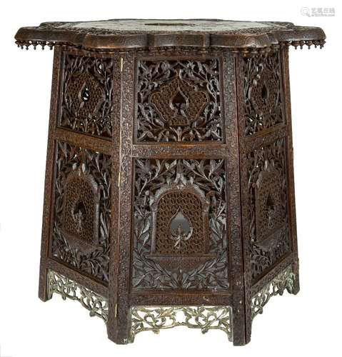 A brass and copper inlaid carved wood table top and stand