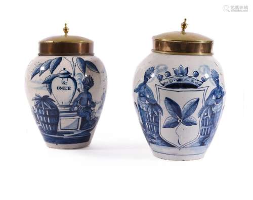 TWO SIMILAR DUTCH DELFT TOBACCO JARS WITH GILT METAL COVERS,...