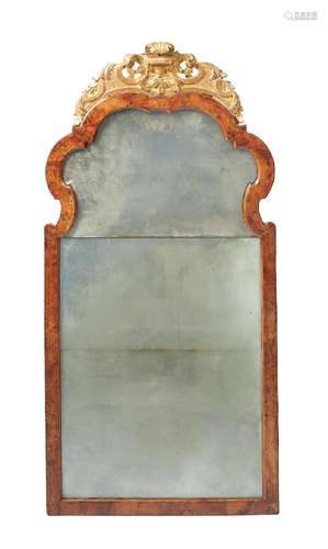 A GEORGE II FIGURED WALNUT AND CARVED GILTWOOD MIRROR, CIRCA...