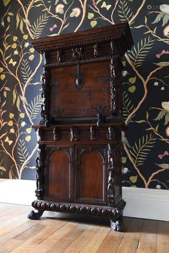 AN ITALIAN CARVED WALNUT STUDIOLO OR WRITING CABINET, 16TH C...