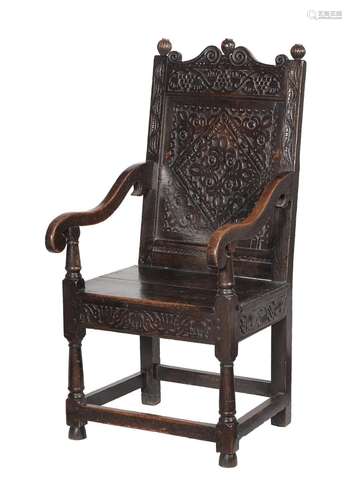 A CHARLES II CARVED OAK PANEL BACK ARMCHAIR, POSSIBLY YORKSH...