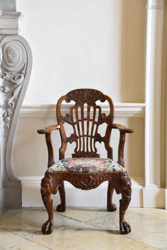 A GEORGE II CARVED WALNUT OPEN ARMCHAIR, ATTRIBUTED TO DANIE...