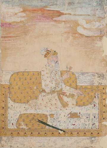 A Mughal portrait of a kneeling nobleman holding a flower