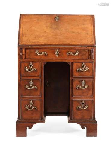 A GEORGE III MAHOGANY AND CROSS BANDED KNEEHOLE BUREAU, CIRC...