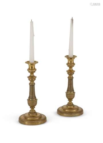 A PAIR OF FRENCH BRASS CANDLESTICKS, IN THE EMPIRE MANNER, L...