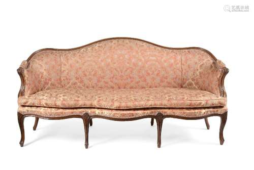 A CARVED WALNUT AND UPHOLSTERED SOFA, PROBABLY FRENCH, CIRCA...
