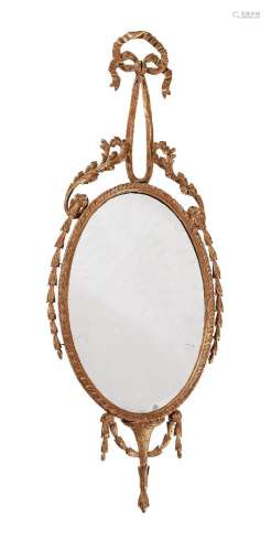 A GEORGE III CARVED GILTWOOD OVAL WALL MIRROR, AFTER DESIGNS...