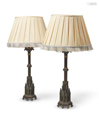 A PAIR OF BRONZE AND GILT TABLE LAMPS IN THE GOTHIC REVIVAL ...
