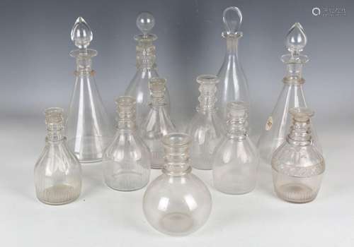 A large group of glass decanters and some stoppers, 19th and...