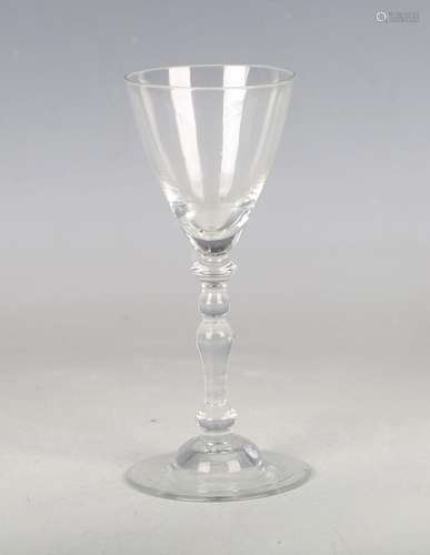 A balustroid wine glass, mid-18th century, the pointed round...