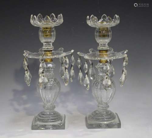 A pair of clear cut glass lustres, 19th century, the baluste...