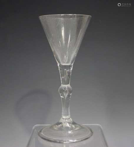 A balustroid wine glass, mid-18th century, the conical bowl ...