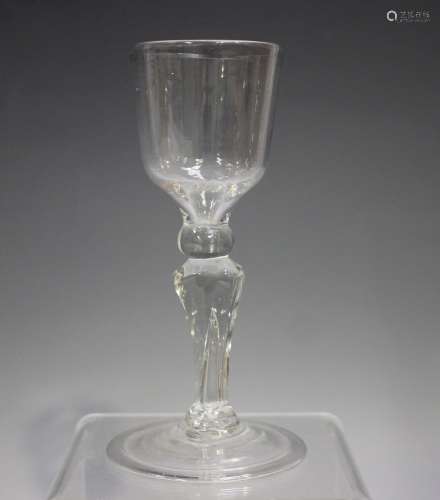 A moulded pedestal stem wine glass, mid-18th century, the og...