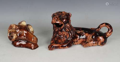 A treacle glazed pottery model of a recumbent lion, early to...