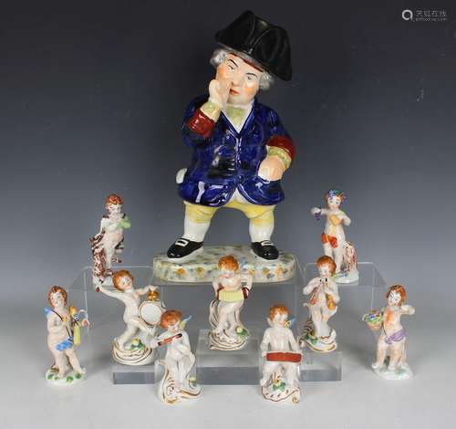 A set of four Continental porcelain cherub figures represent...