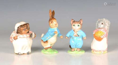 Four Beswick Beatrix Potter figures, each with gold oval bac...