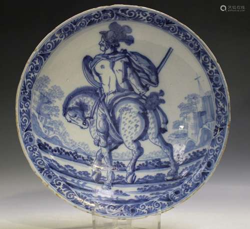 A Dutch Delft dish, 18th century, painted in blue with an eq...