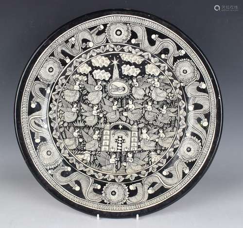 A Mexican folk art pottery circular charger by Felix Venanci...