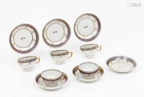 A set of five cups and six saucers